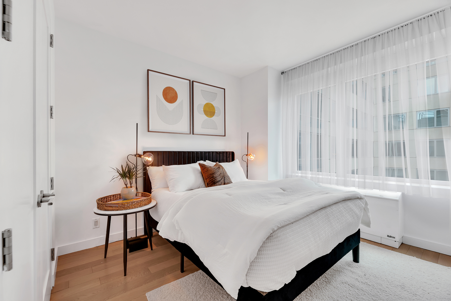 34 North 7th Street, Unit 7E Brooklyn, NY 11249 - Photo 4 of 20 a bedroom with a bed and a table in it