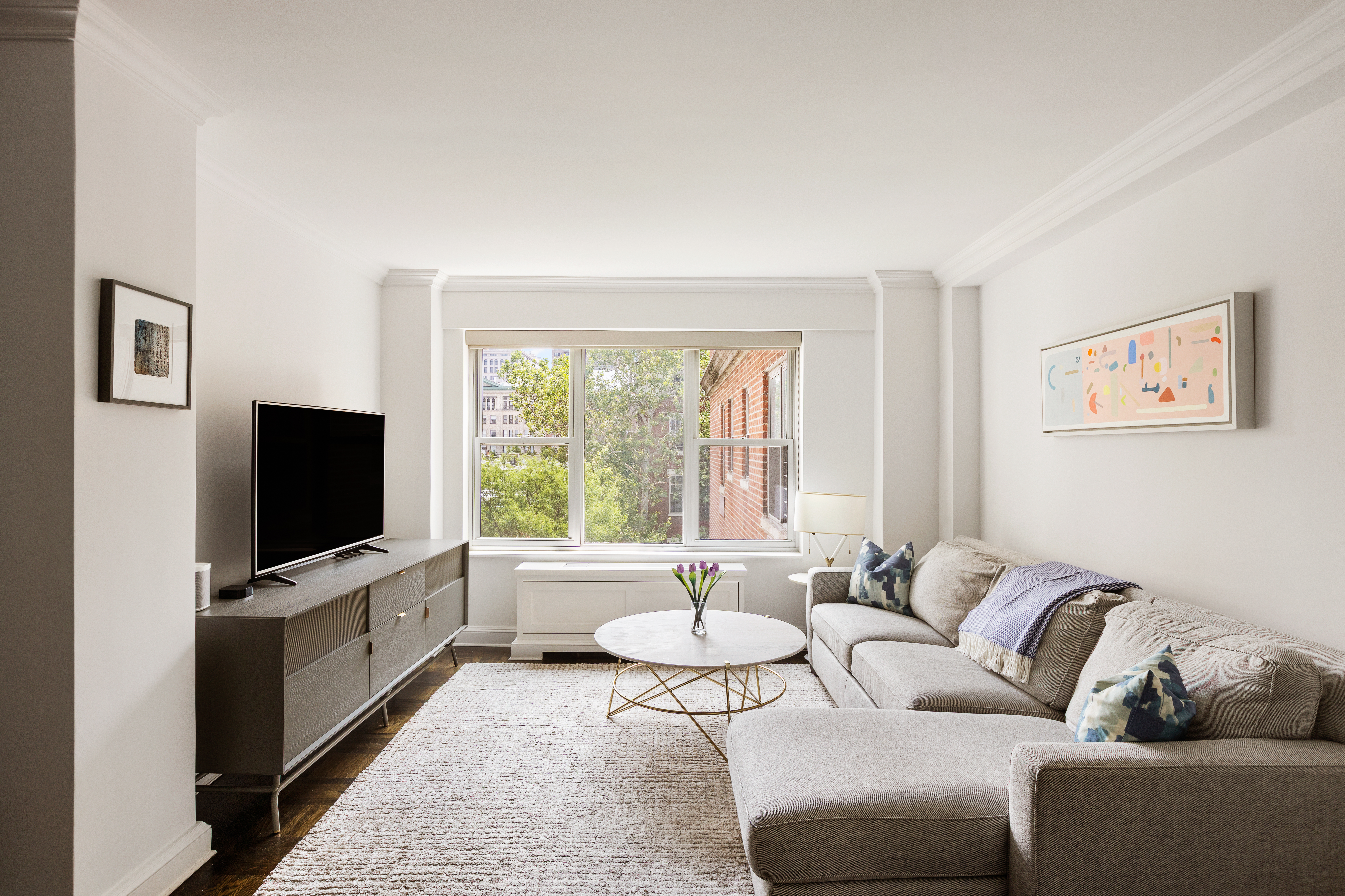a living room with furniture and a flat screen tv