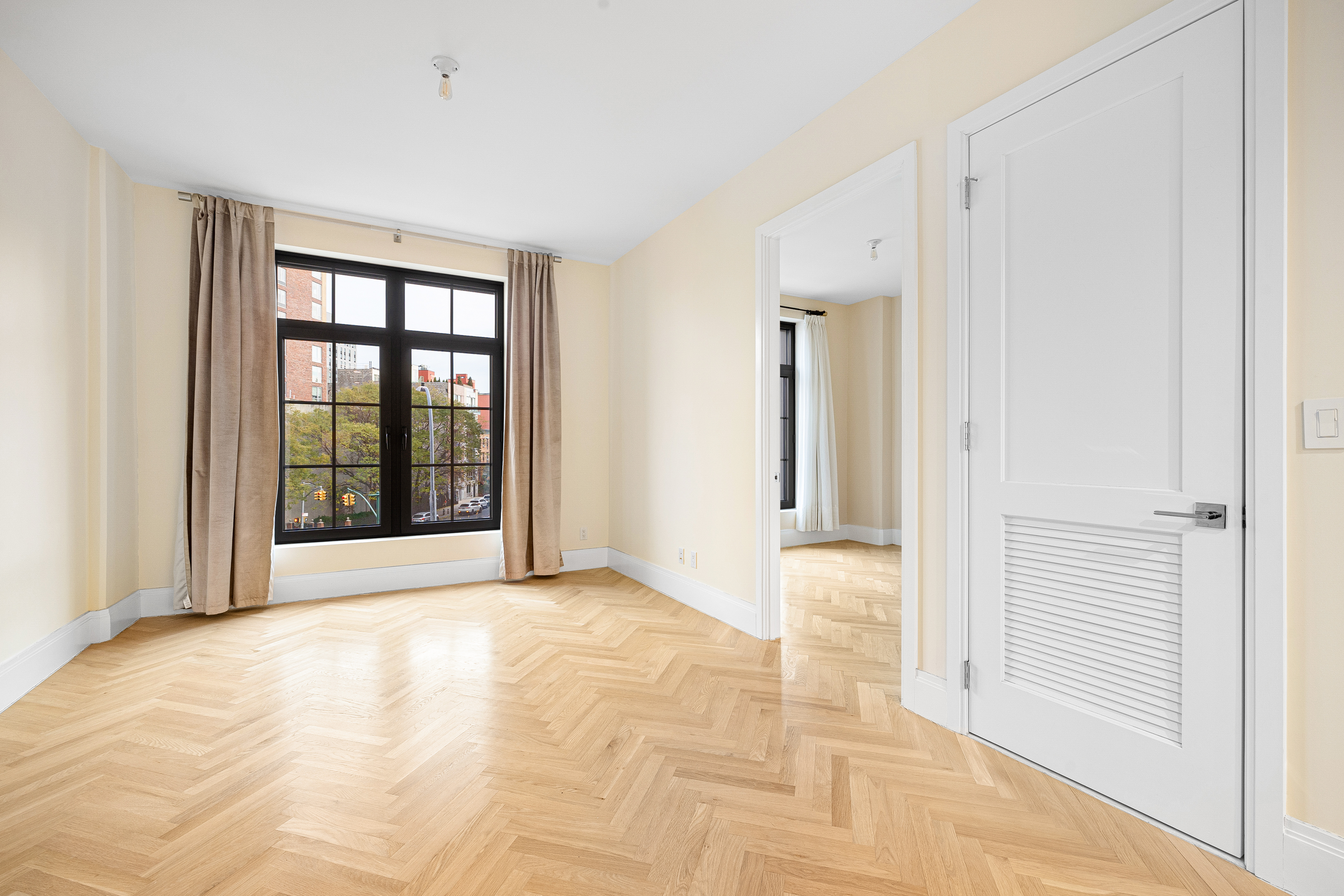 300 West 122nd Street, Unit 4F Manhattan, NY 10027 - Photo 4 of 32 a view of an empty room with glass door and a window
