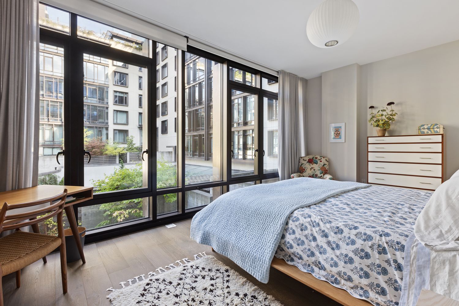 a bedroom with a bed and a large window