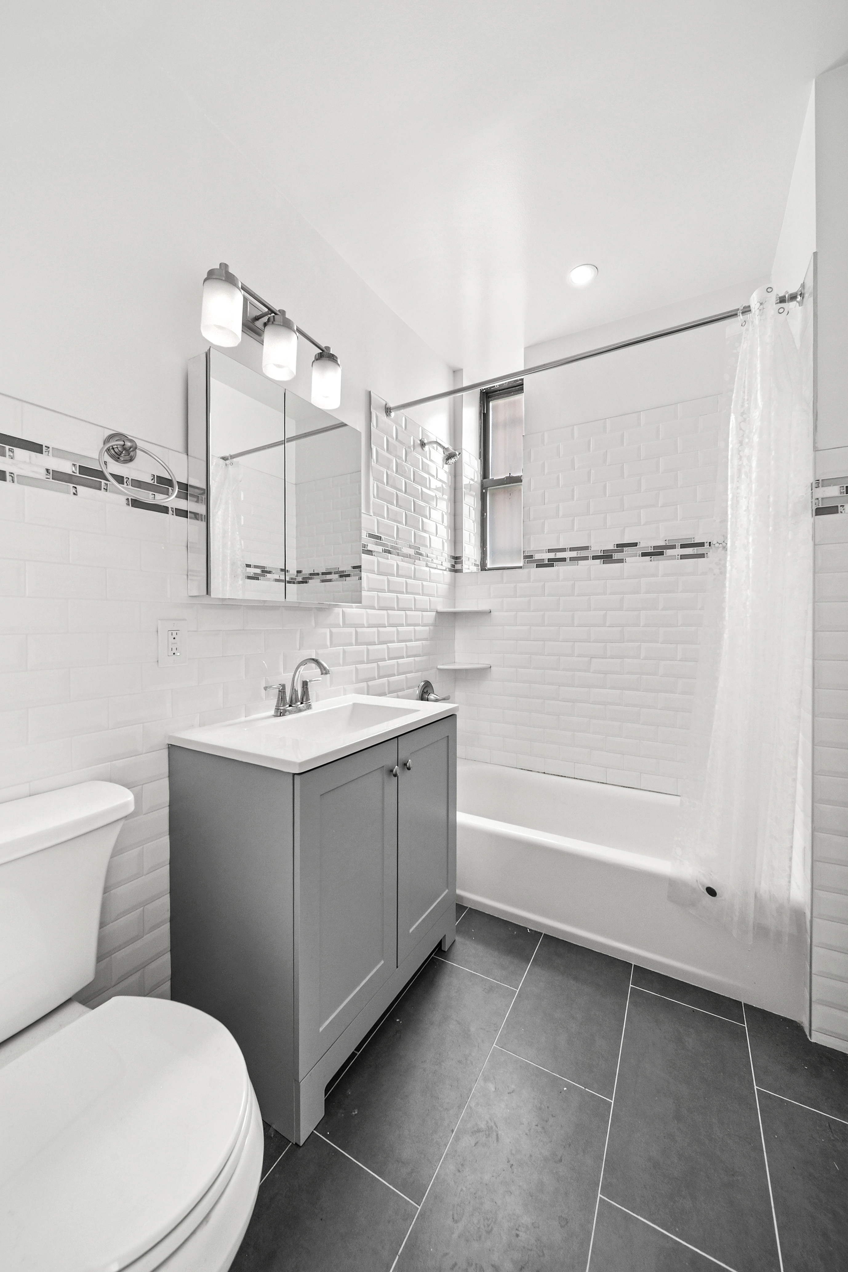 159-00 Riverside Drive West, Unit 1L70 Manhattan, NY 10032 - Photo 7 of 17 a bathroom with a sink a toilet and shower
