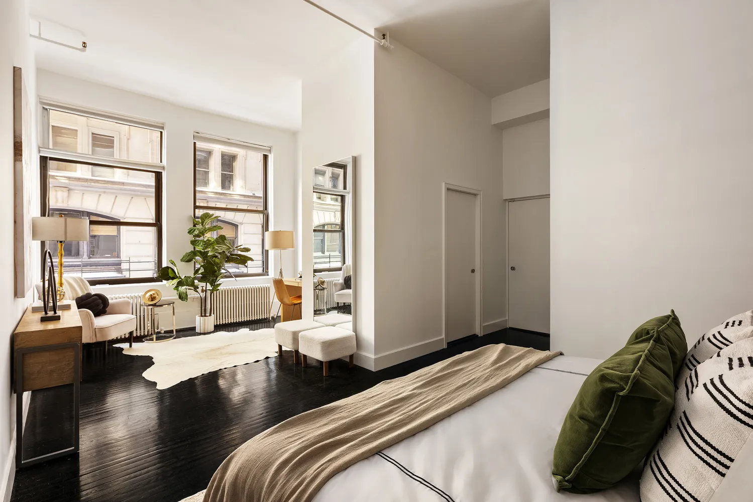 a bedroom with a bed and wooden floor