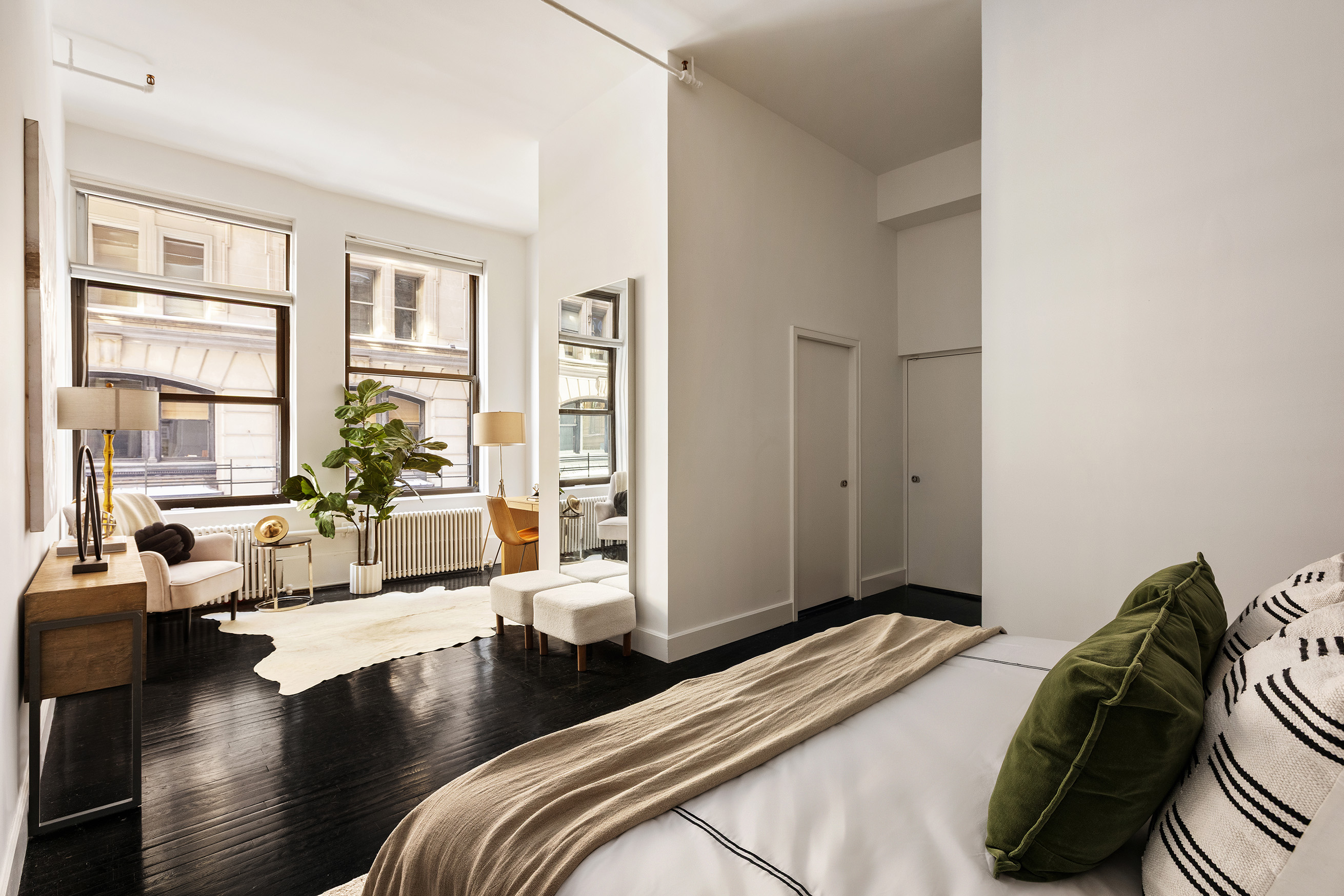 142 5th Avenue, Unit 2 Manhattan, NY 10011 - Photo 14 of 18 a bedroom with a bed and wooden floor