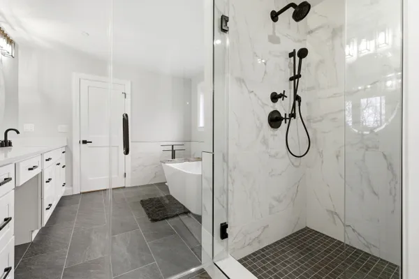 a bathroom with a bathtub and shower