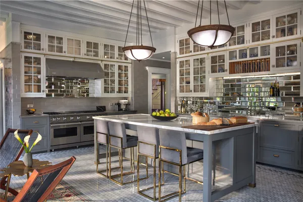 a kitchen with granite countertop a stove and chairs