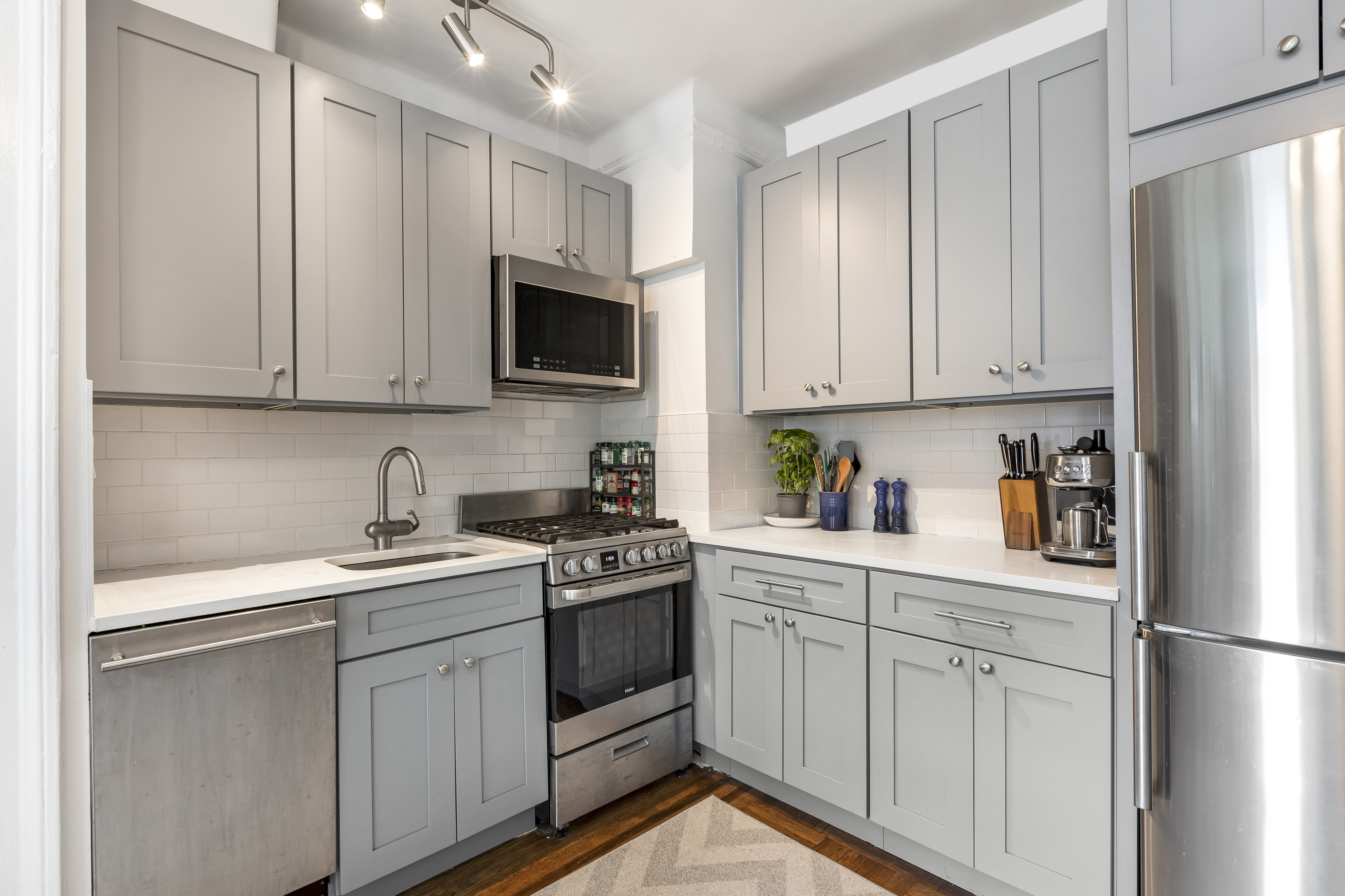 30 Clinton Street, Unit 6A Brooklyn, NY 11201 - Photo 7 of 11 a kitchen with stainless steel appliances granite countertop white cabinets sink and a refrigerator