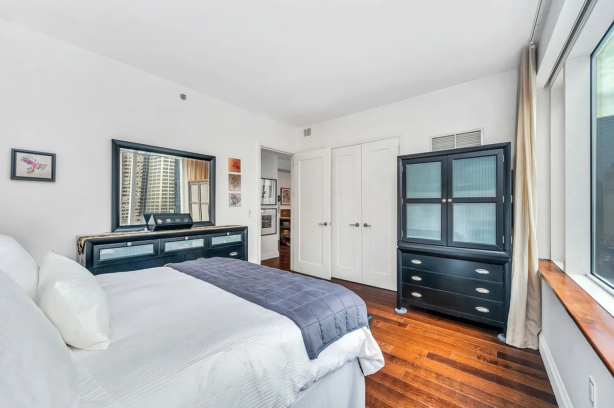 70 Little West Street, Unit 15A Manhattan, NY 10004 - Photo 8 of 19 a bedroom with a bed and a window