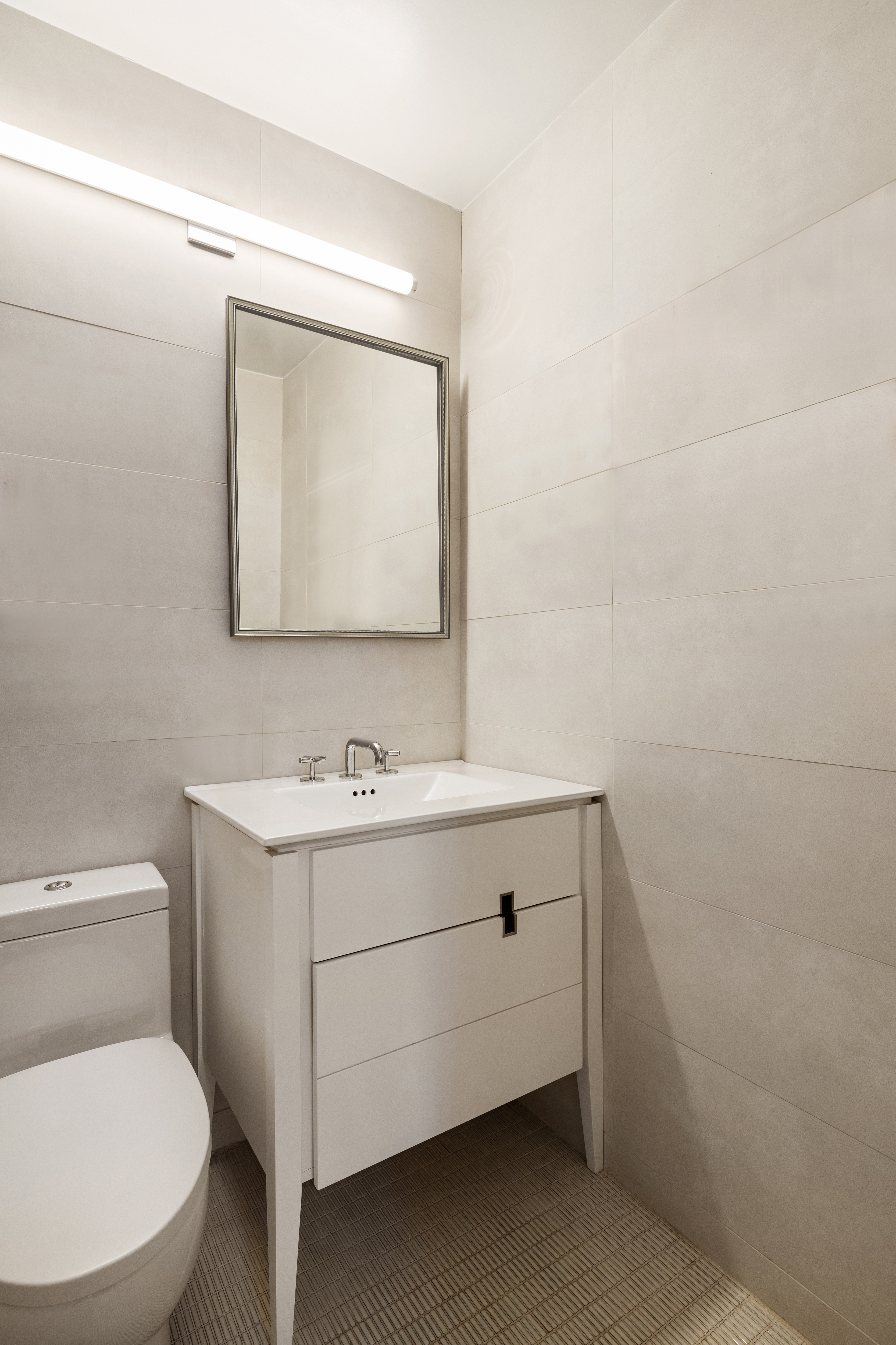 1 Irving Place, Unit P20G Manhattan, NY 10003 - Photo 7 of 8 a bathroom with a toilet sink and mirror