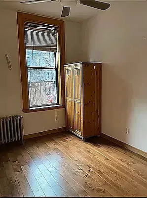 1278 1st Avenue, Unit 5 Manhattan, NY 10065 - Photo 5 of 5 an empty room with wooden floor and windows