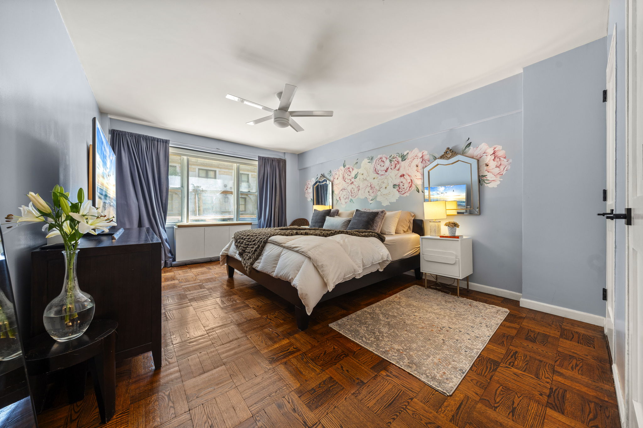 310 Lexington Avenue, Unit 2J Manhattan, NY 10016 - Photo 9 of 11 a bedroom with a bed table flowerpot and window