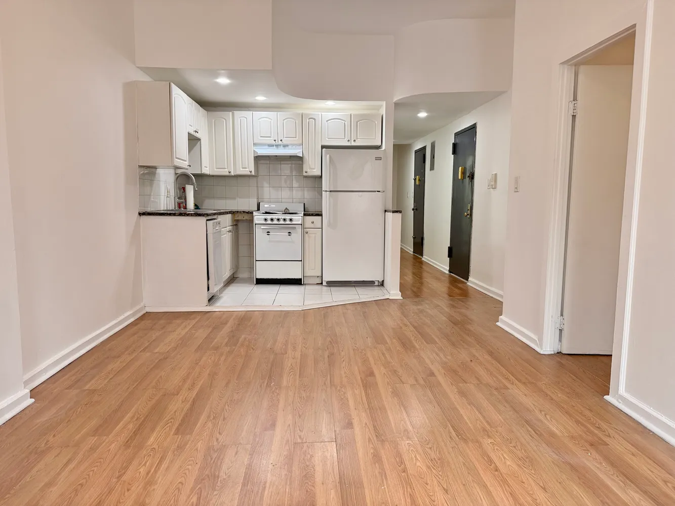 a view of kitchen with wooden floor and electronic appliances