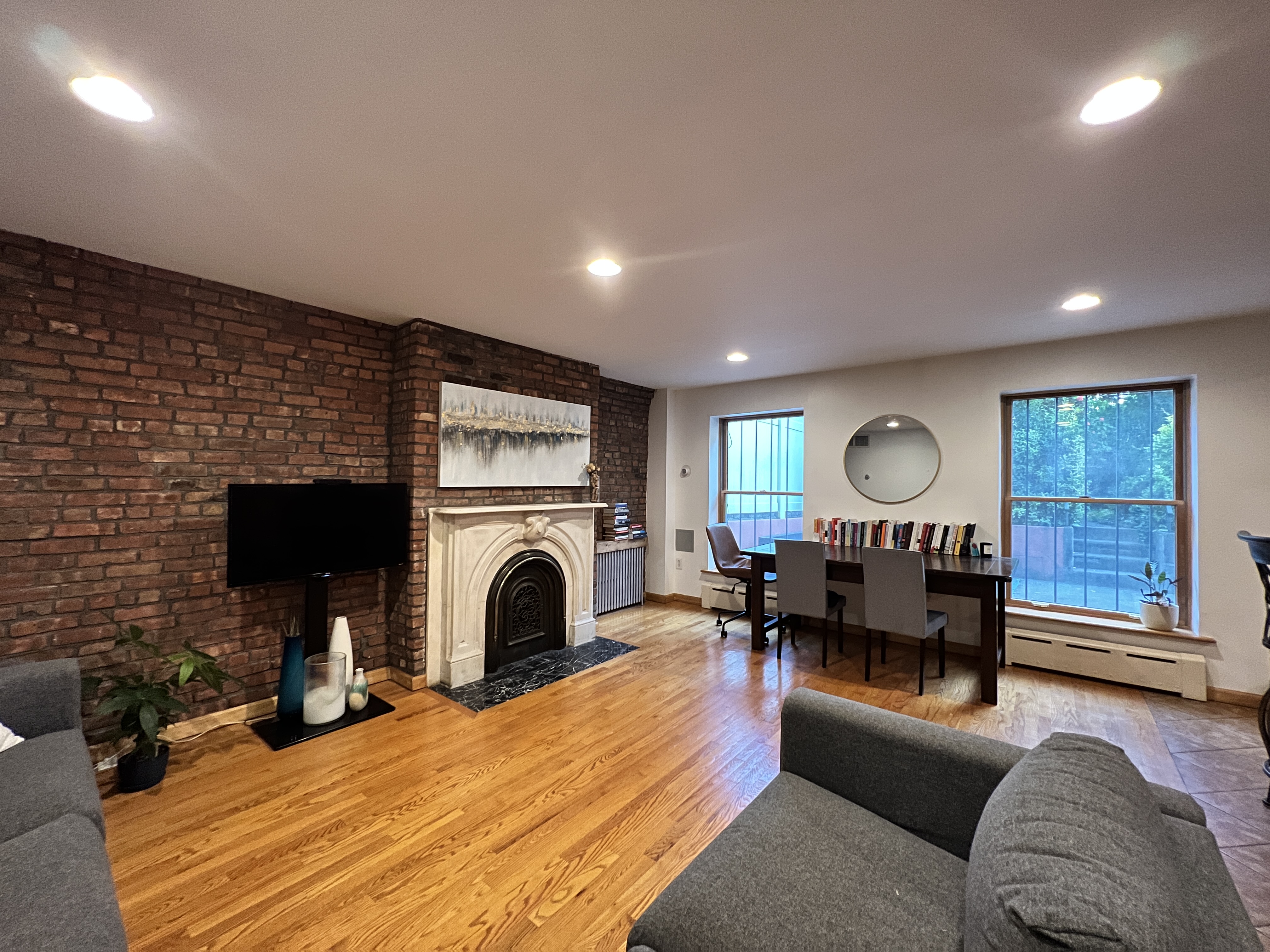 a living room with furniture a fireplace and a flat screen tv