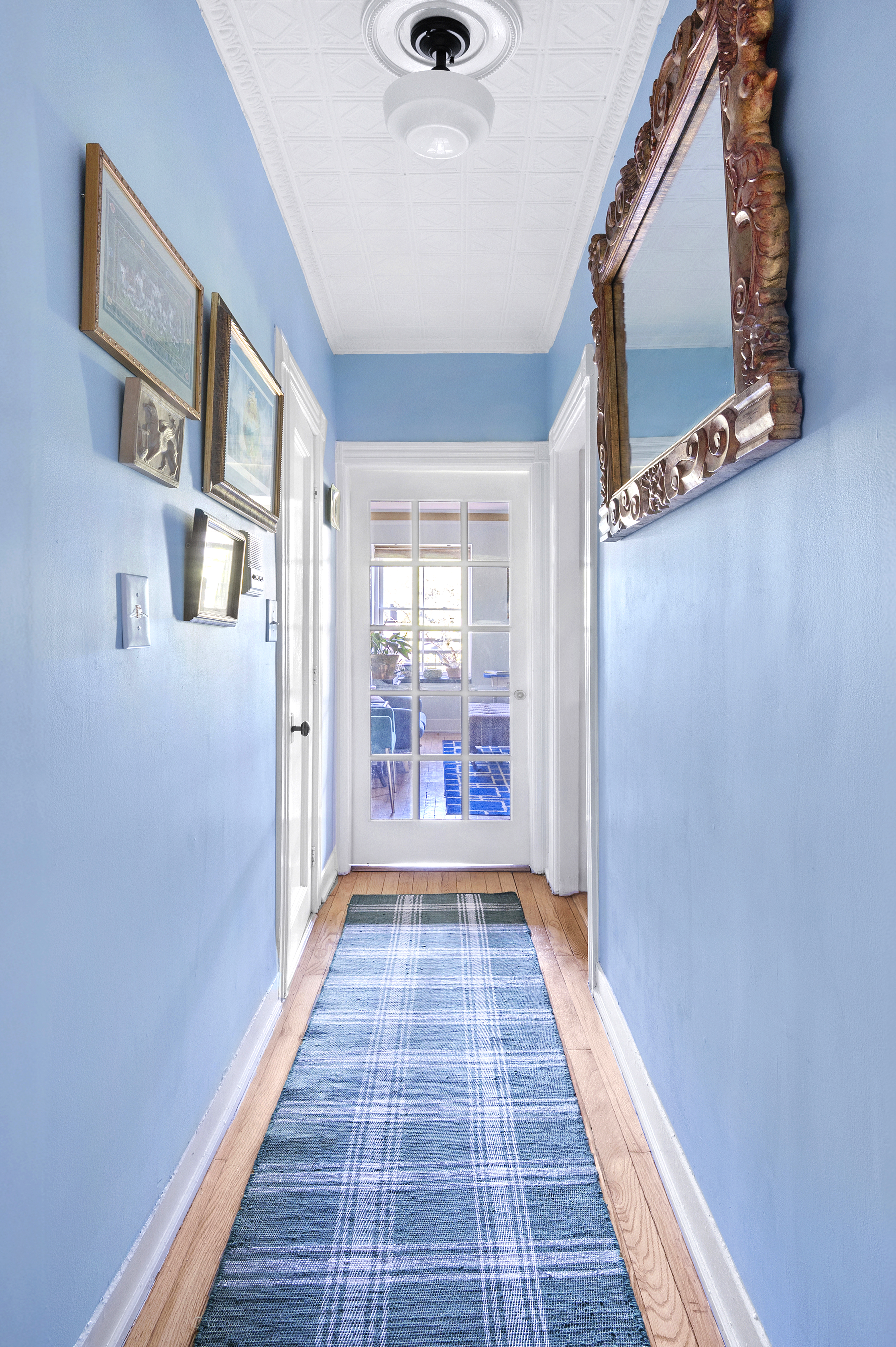 306 West 4th Street, Unit D3 Manhattan, NY 10014 - Photo 4 of 9 a view of a hallway view with wooden floor and staircase