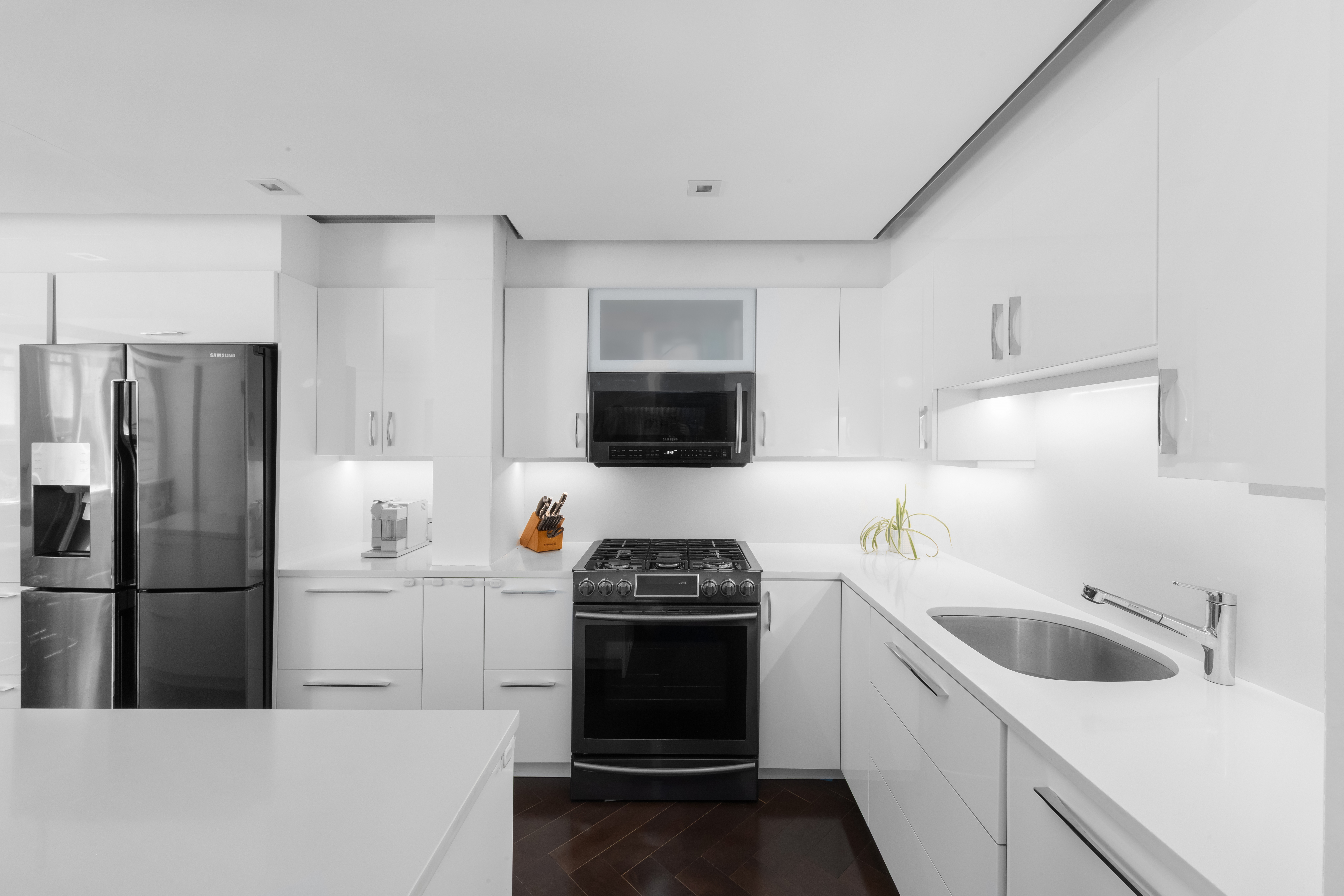 207 East 74th Street, Unit 1J Manhattan, NY 10021 - Photo 4 of 9 a kitchen with a refrigerator sink and stove