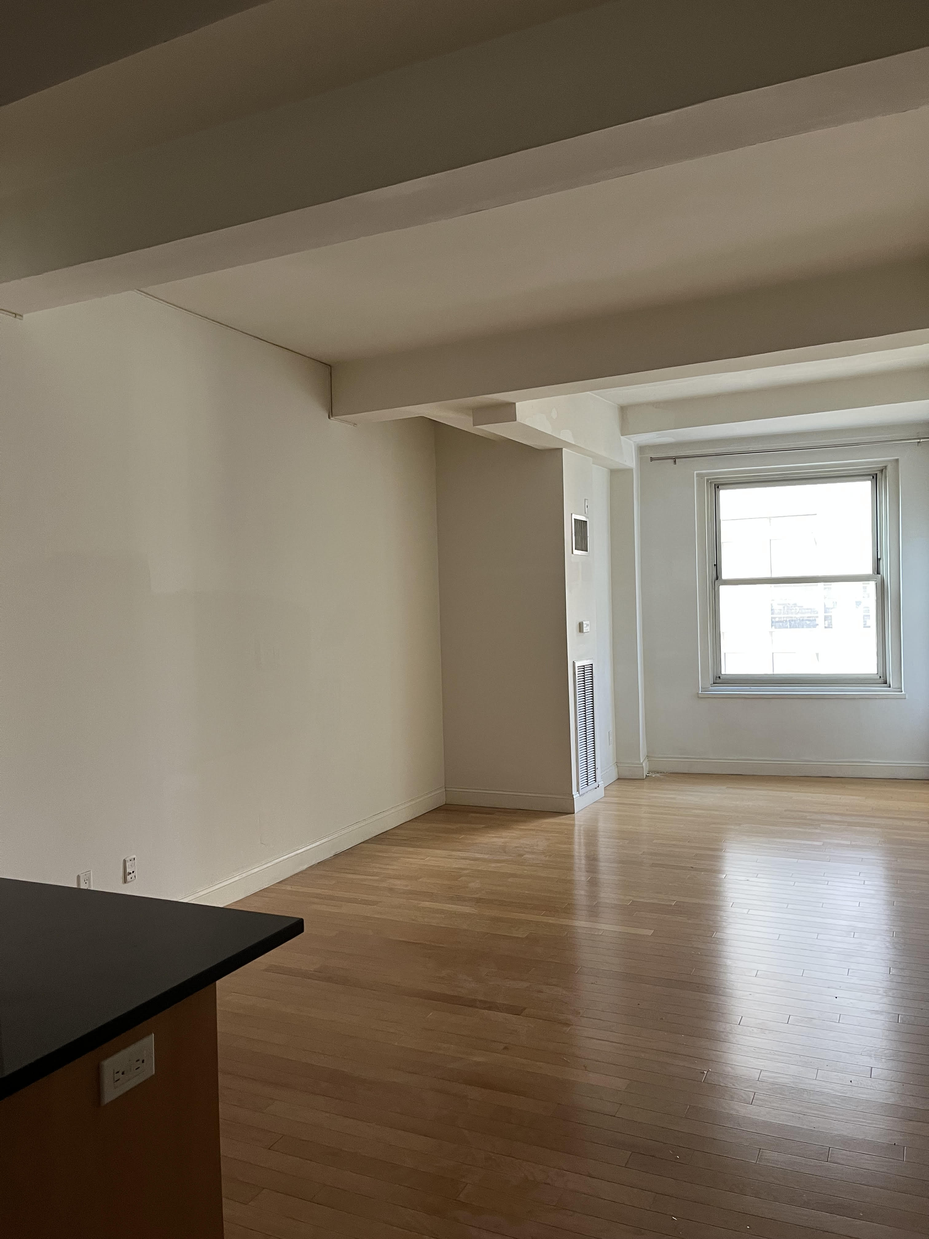 88 Greenwich Street, Unit 821 Manhattan, NY 10006 - Photo 2 of 10 a view of an empty room with wooden floor and a window
