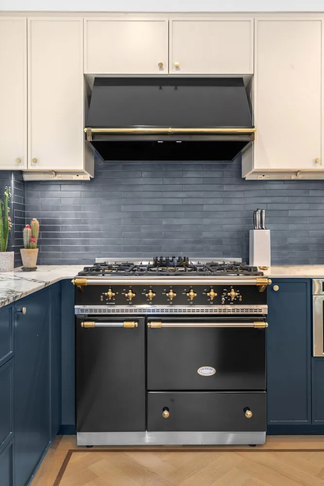 a stove top oven sitting inside of a kitchen