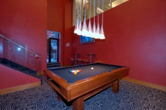 20 West Street, Unit 43E Manhattan, NY 10004 - Photo 9 of 10 a view of a room with pool table and a chandelier
