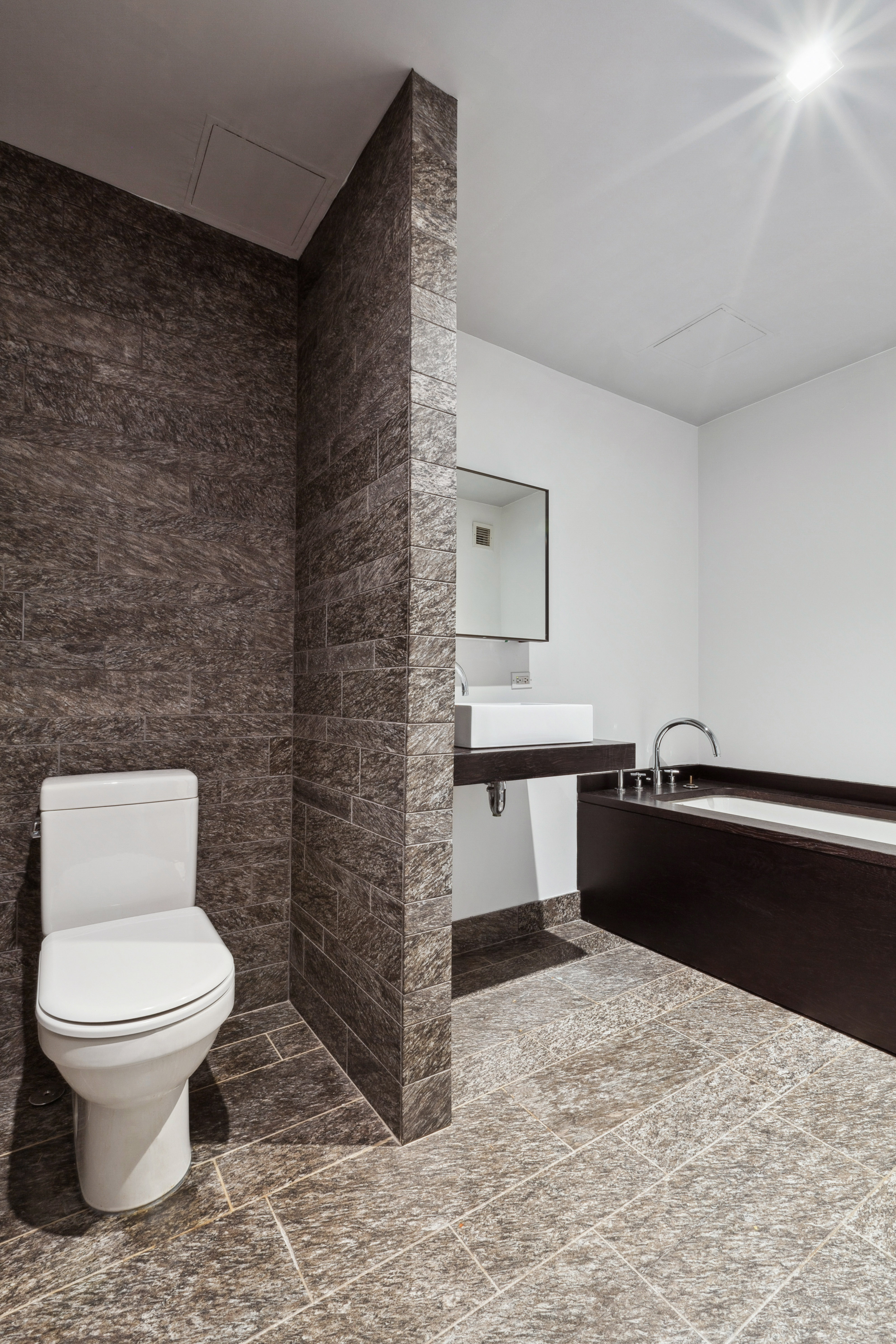 20 Pine Street, Unit 2905 Manhattan, NY 10005 - Photo 5 of 14 a bathroom with a toilet and a bathtub