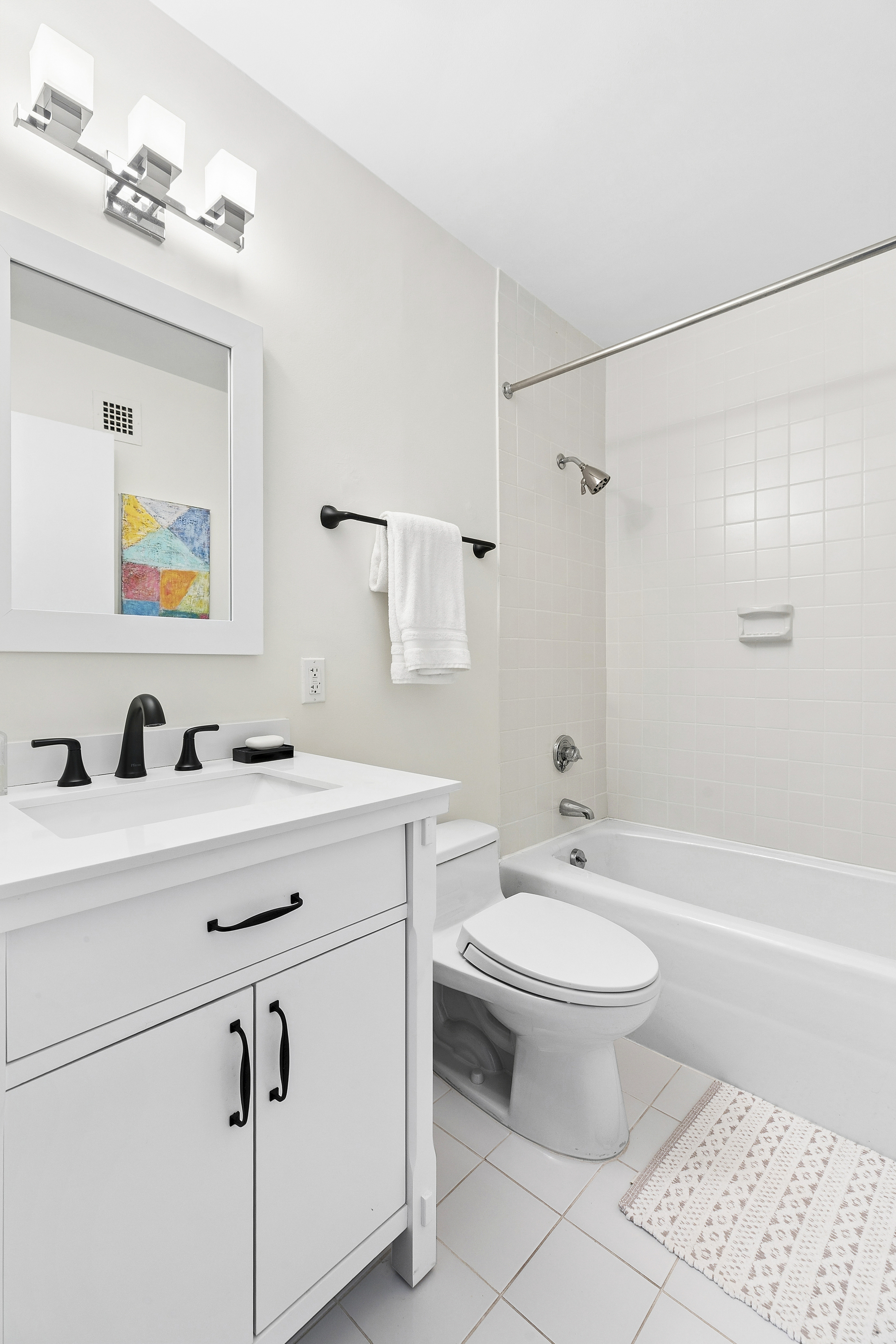 1065 Park Avenue, Unit 4BC Manhattan, NY 10128 - Photo 12 of 16 a bathroom with a sink toilet a mirror and shower