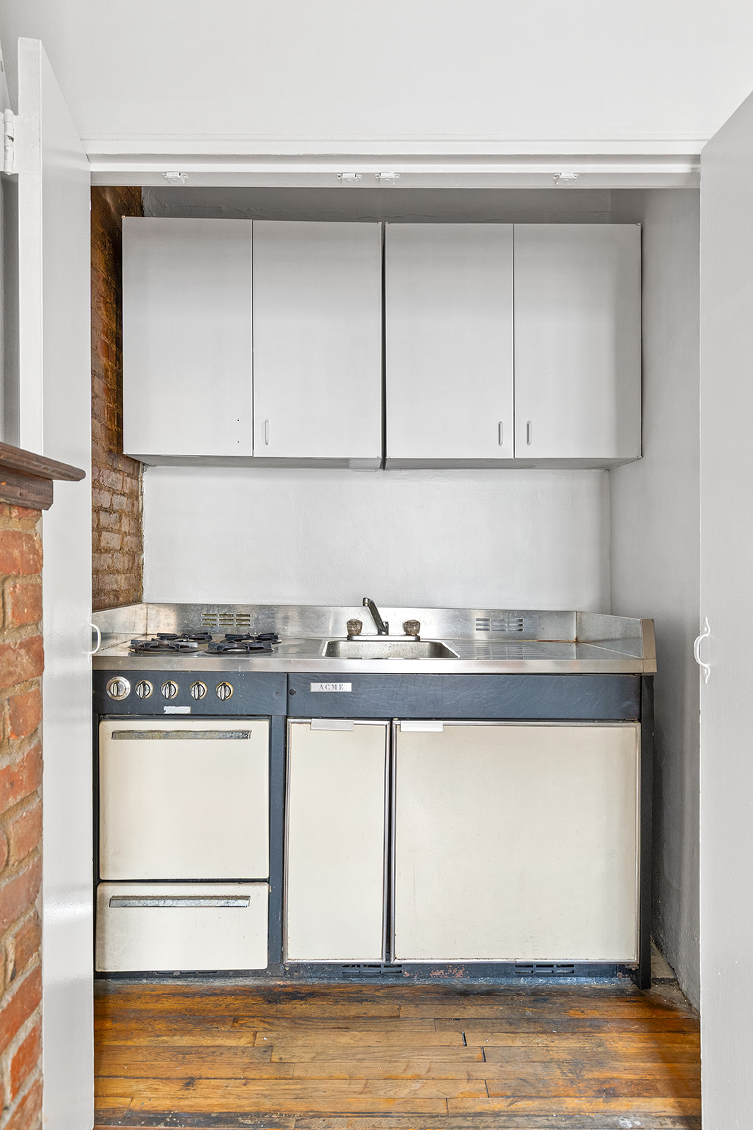 127 West 95th Street Manhattan, NY 10025 - Photo 10 of 15 a kitchen with granite countertop a stove and a microwave