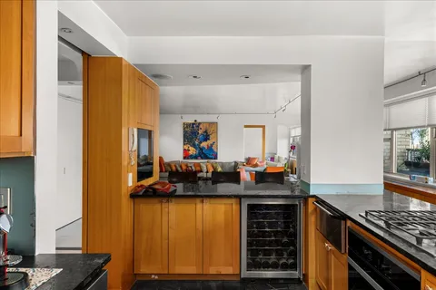 a kitchen with sink and refrigerator