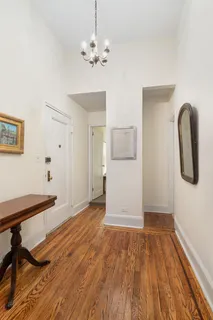 a room with wooden floor and white walls