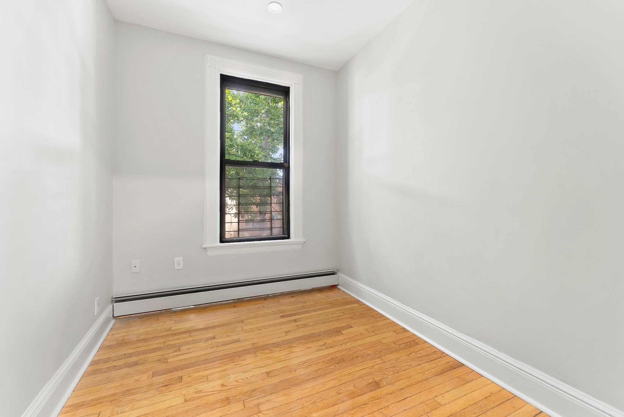 1414 30th Road Queens, NY 11102 - Photo 9 of 16 an empty room with a window