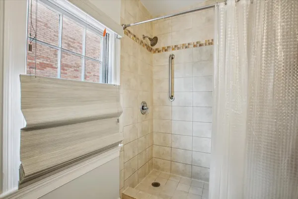 a bathroom with a shower and a sink