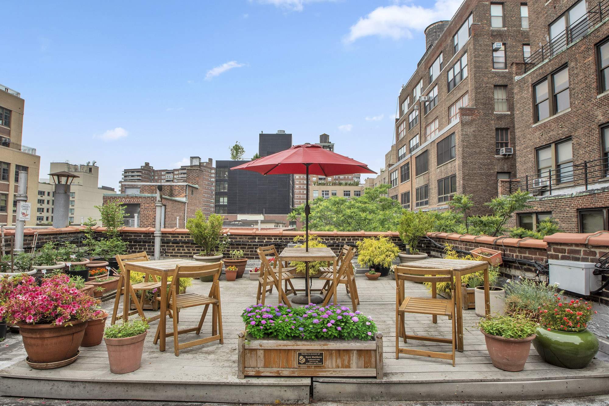 225 West 25th Street, Unit 5K Manhattan, NY 10001 - Photo 12 of 17 a city street filled with lots of potted plants