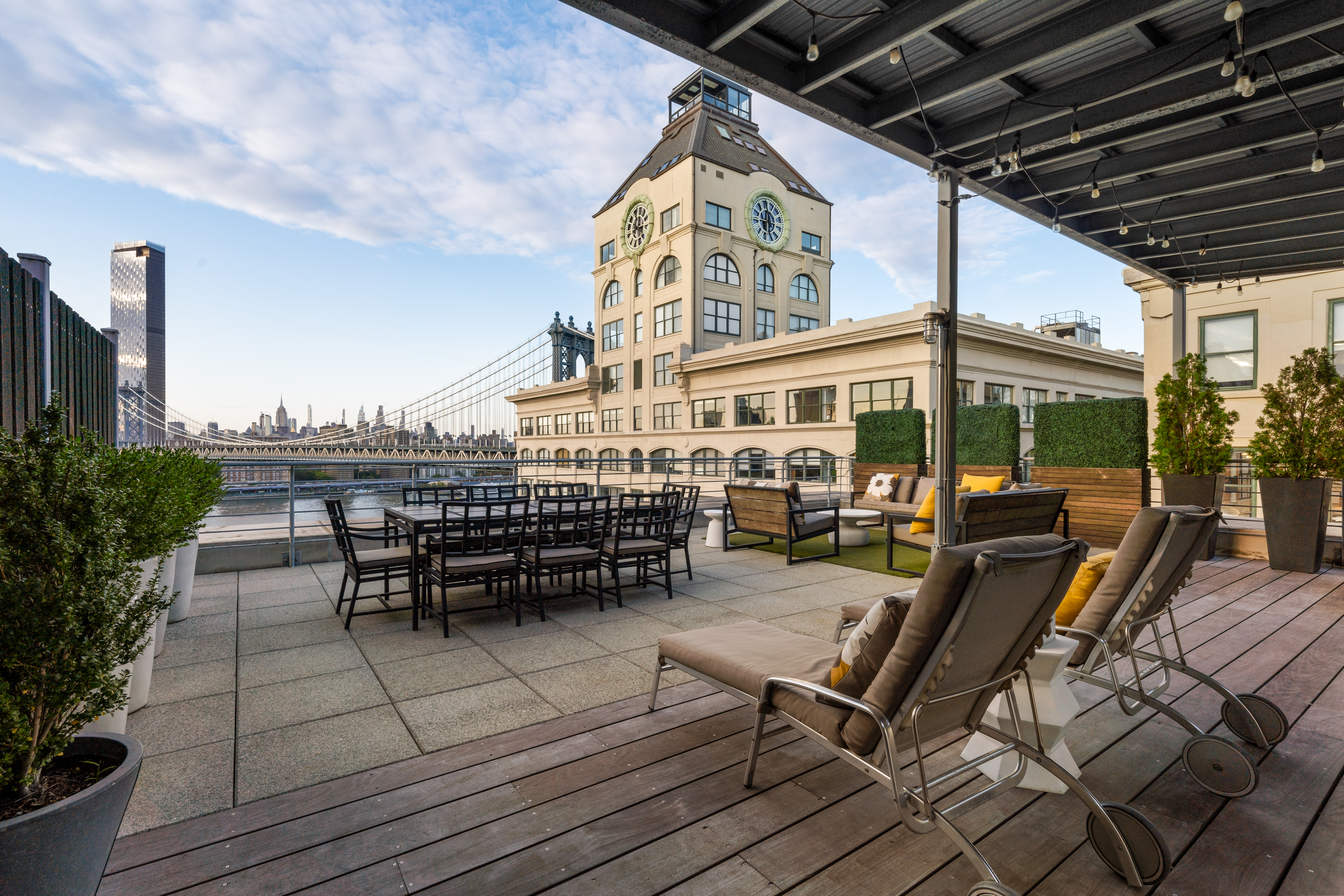 30 Main Street, Unit PHB Brooklyn, NY 11201 - Photo 27 of 33 a view of a roof deck with table and chairs under an umbrella with a barbeque