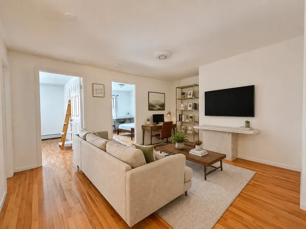 a living room with furniture and a flat screen tv