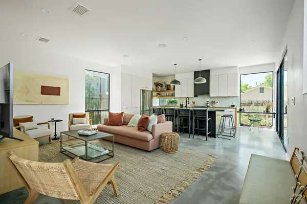 a living room with furniture and kitchen view