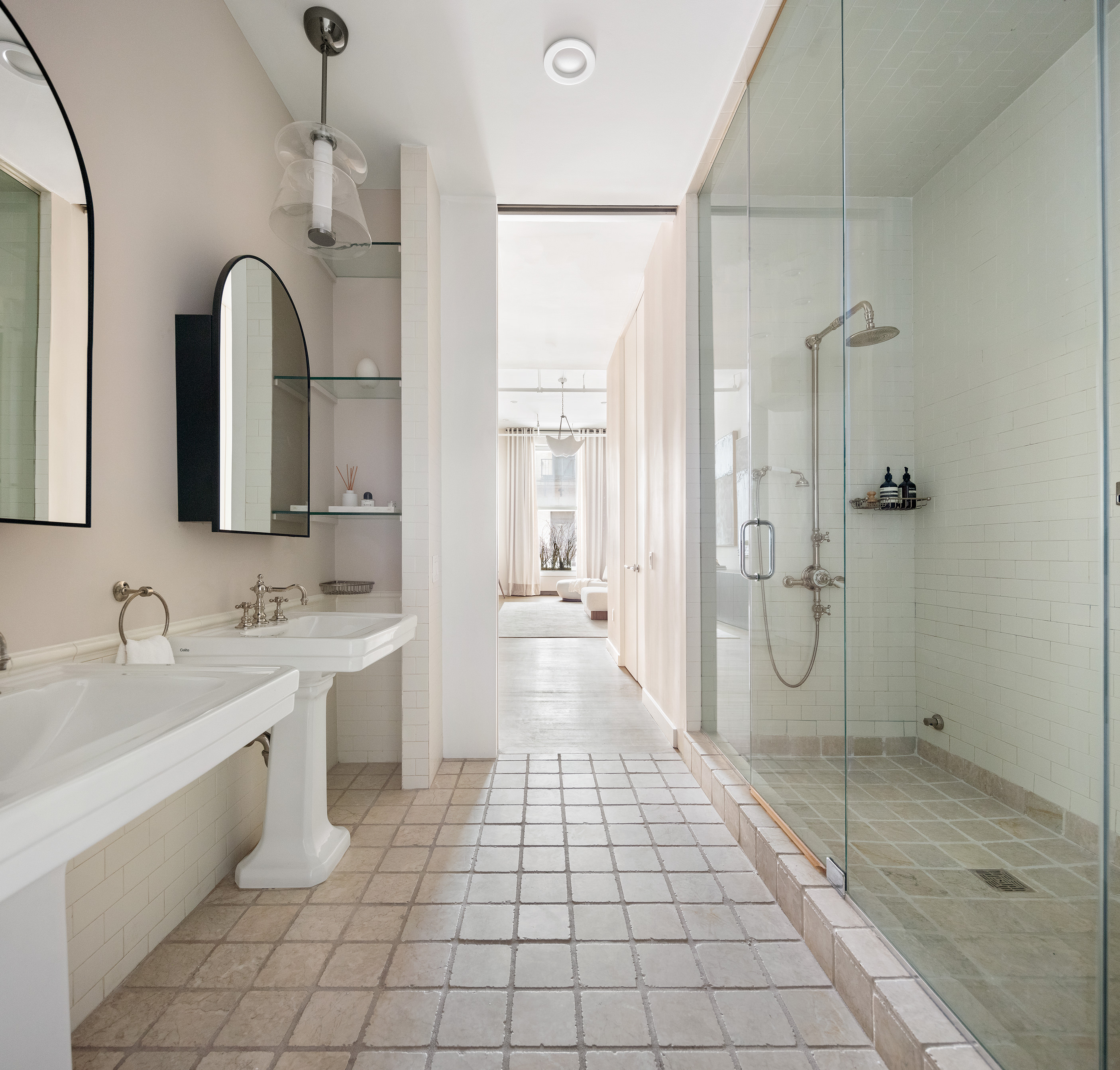 76 Crosby Street, Unit 2A Manhattan, NY 10012 - Photo 8 of 12 a bathroom with a double vanity sink a toilet and a shower