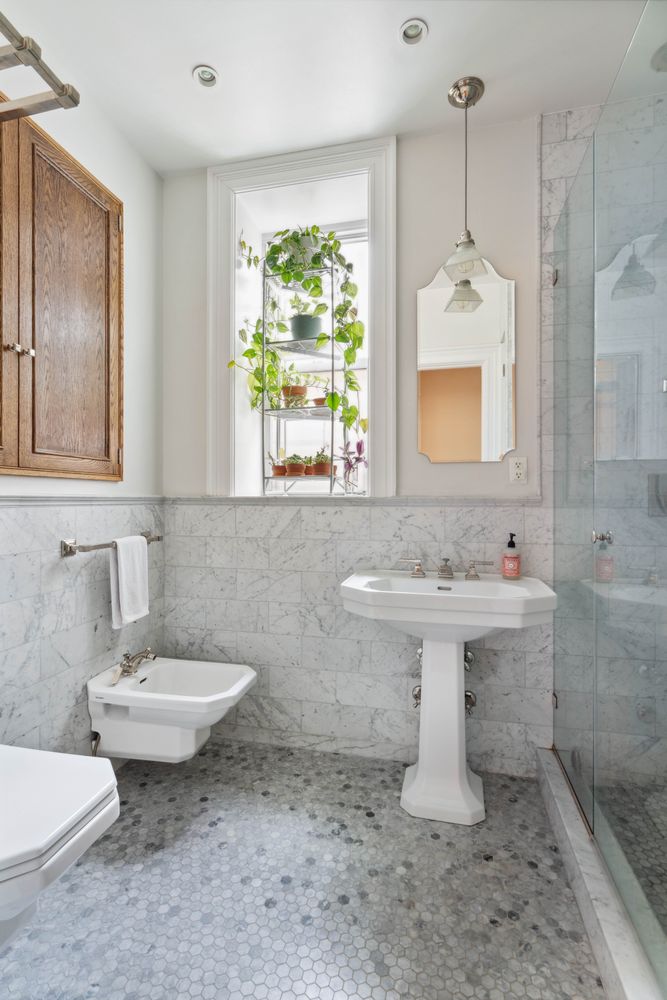 a bathroom with a sink toilet and mirror