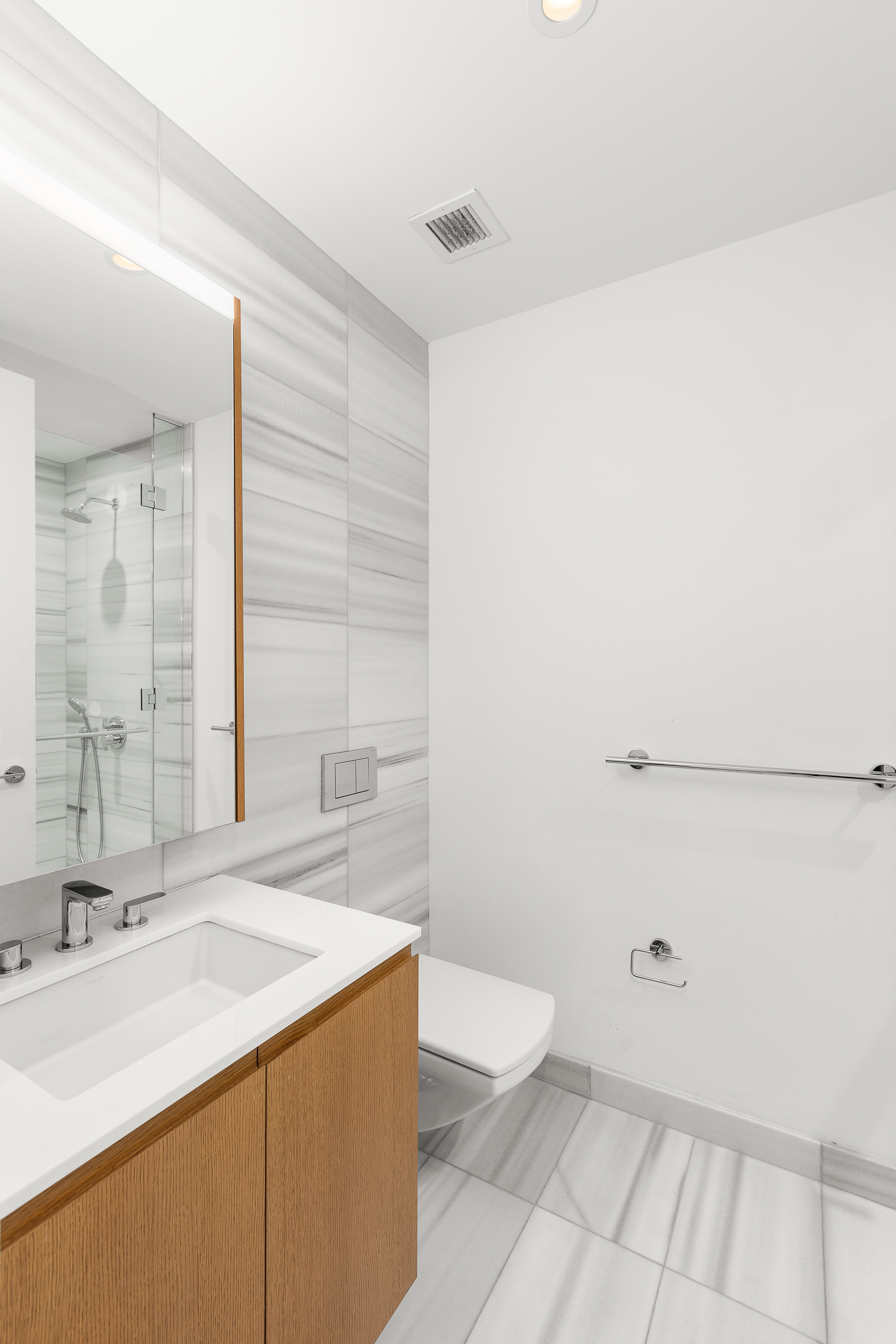 50 West Street, Unit 14B Manhattan, NY 10006 - Photo 10 of 29 a bathroom with a sink a toilet and mirror