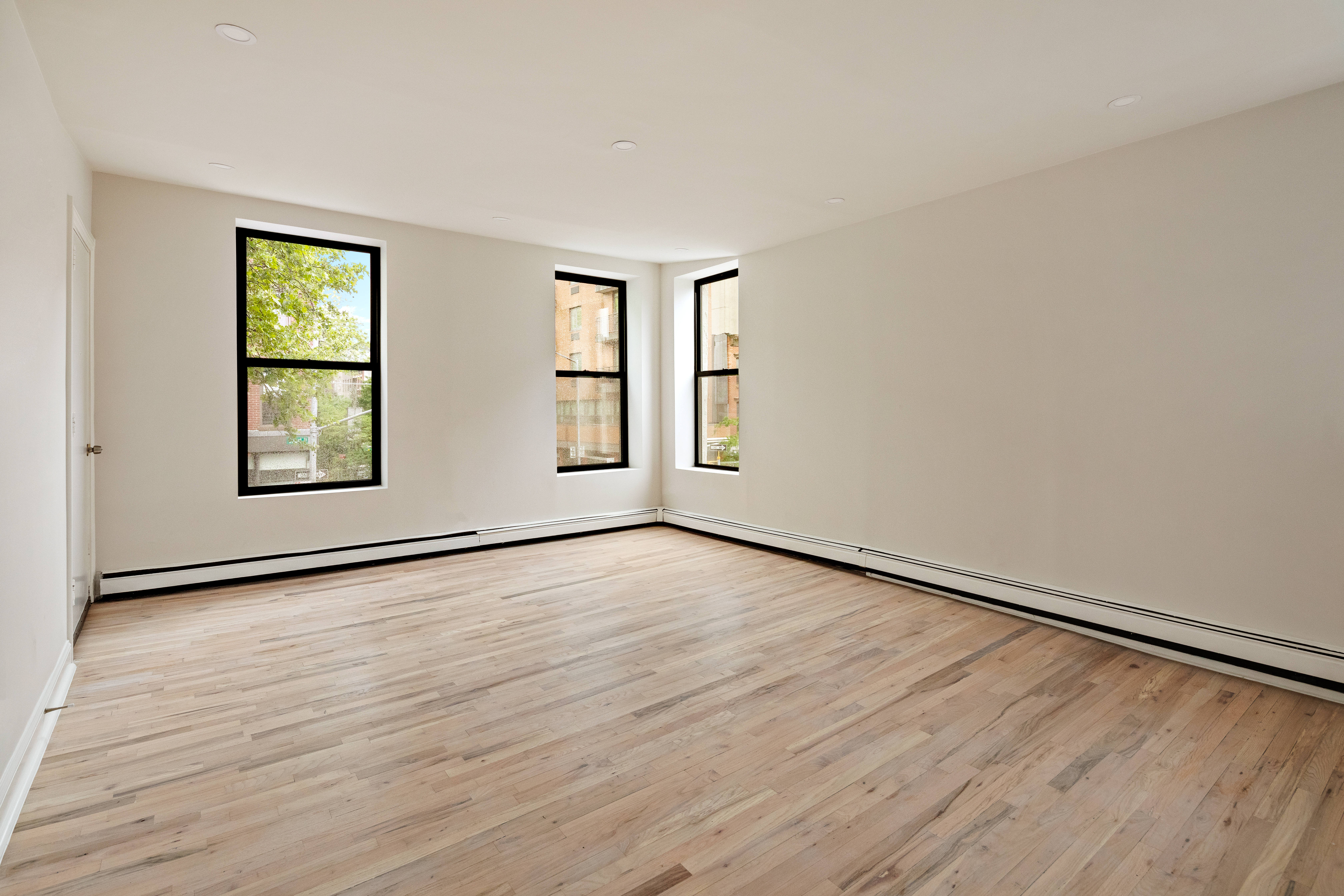 544 Court Street, Unit 2 Brooklyn, NY 11231 - Photo 2 of 9 an empty room with wooden floor and windows