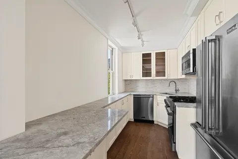 a kitchen with stainless steel appliances granite countertop a stove and a sink