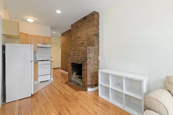 309 East 95th Street, Unit 17 Manhattan, NY 10128 - Photo 2 of 4 a living room with furniture and a fireplace