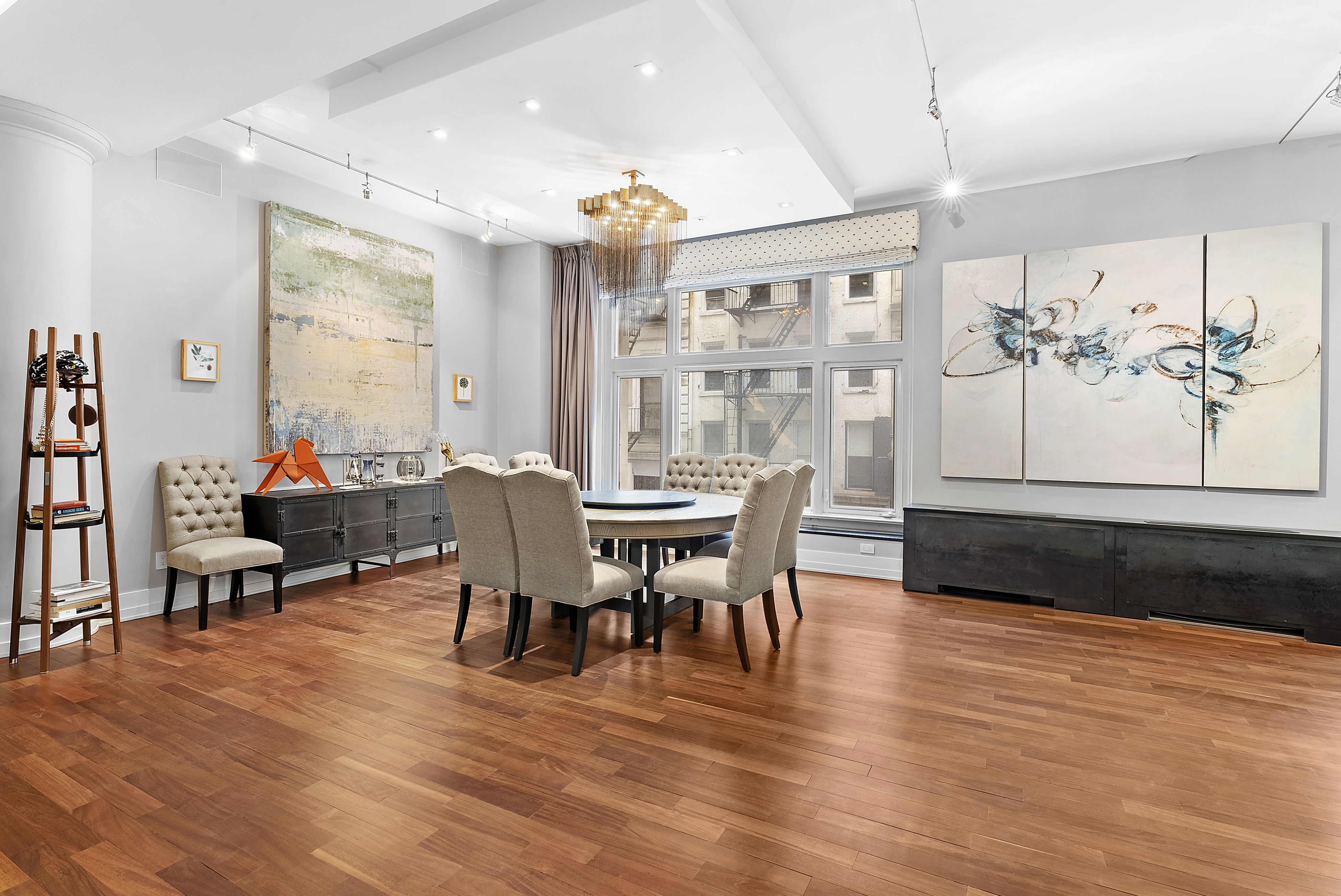 66 Leonard Street, Unit 2A Manhattan, NY 10013 - Photo 3 of 15 a view of a dining room with furniture window and wooden floor