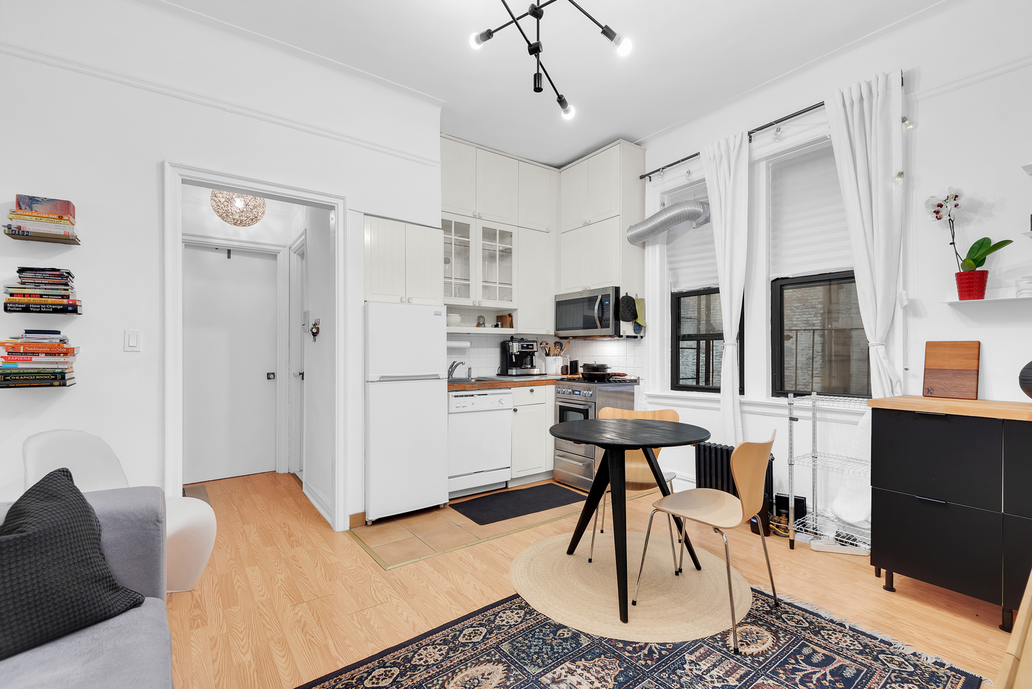 a living room with furniture a dining table and kitchen view