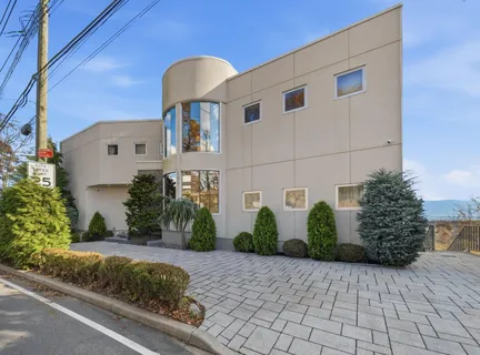 a front view of a house with garden