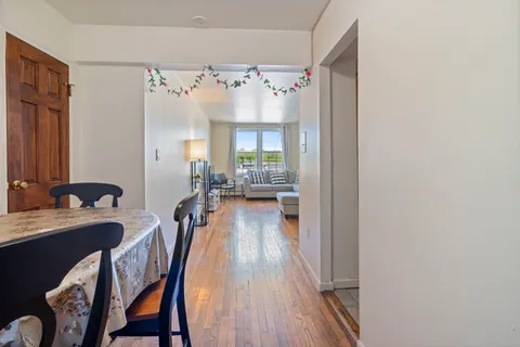 a view of a dining room with furniture window and wooden floor
