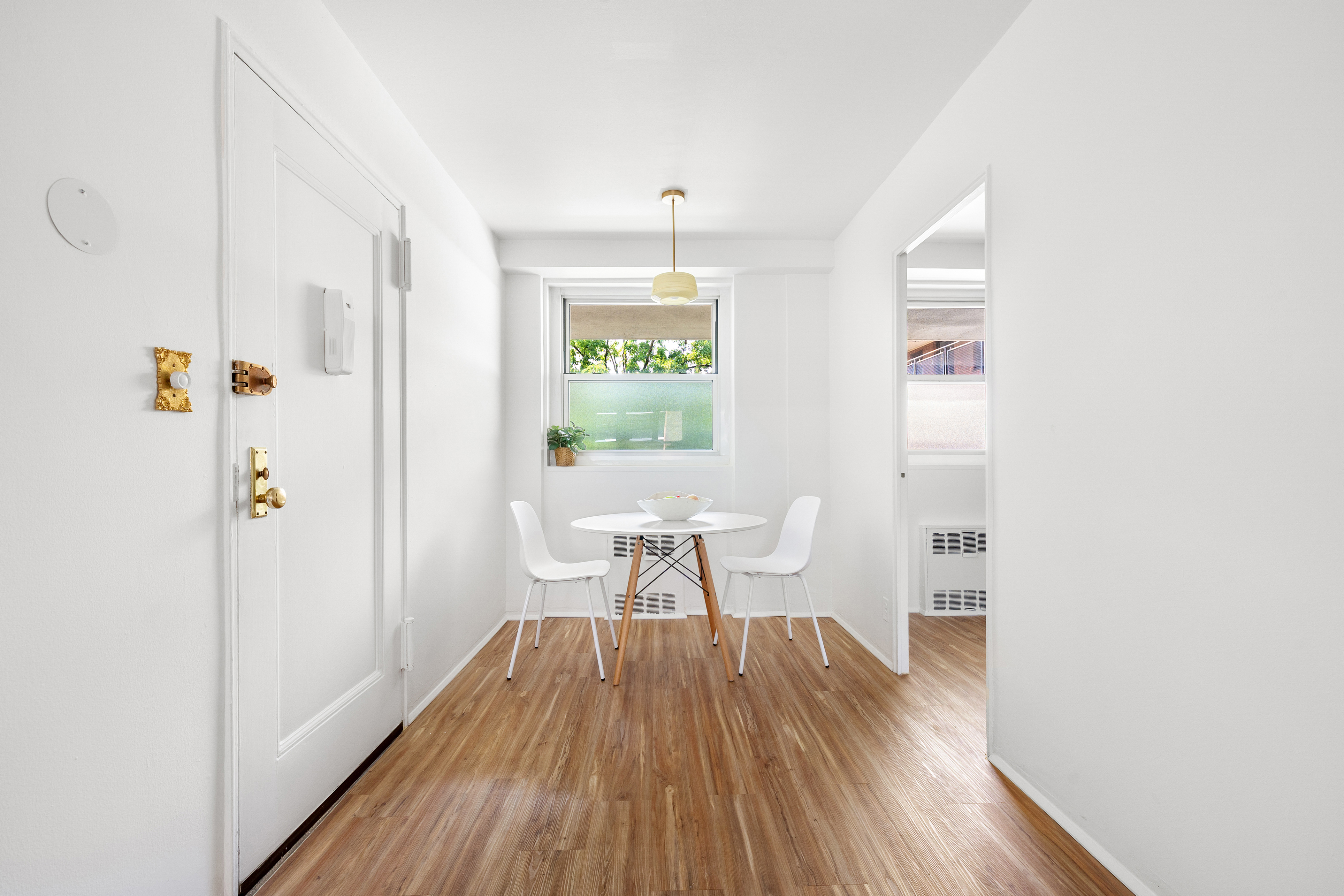 35-31 85th Street, Unit 6C Queens, NY 11372 - Photo 5 of 11 a workspace room with wooden floor and windows