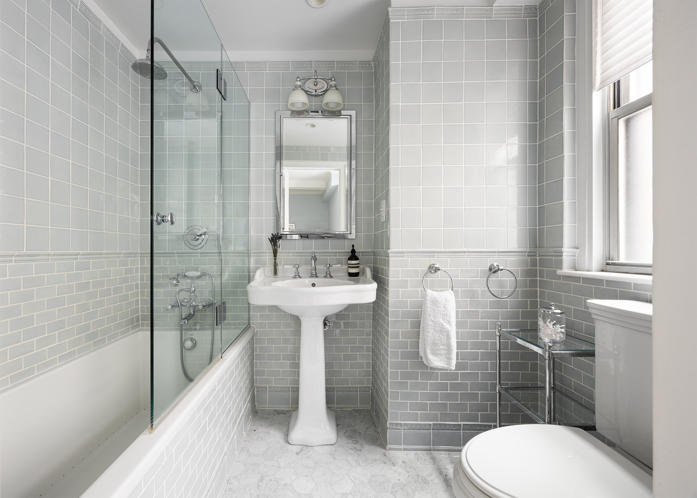 21 East 87th Street, Unit 10D Manhattan, NY 10128 - Photo 10 of 11 a bathroom with a sink toilet and shower