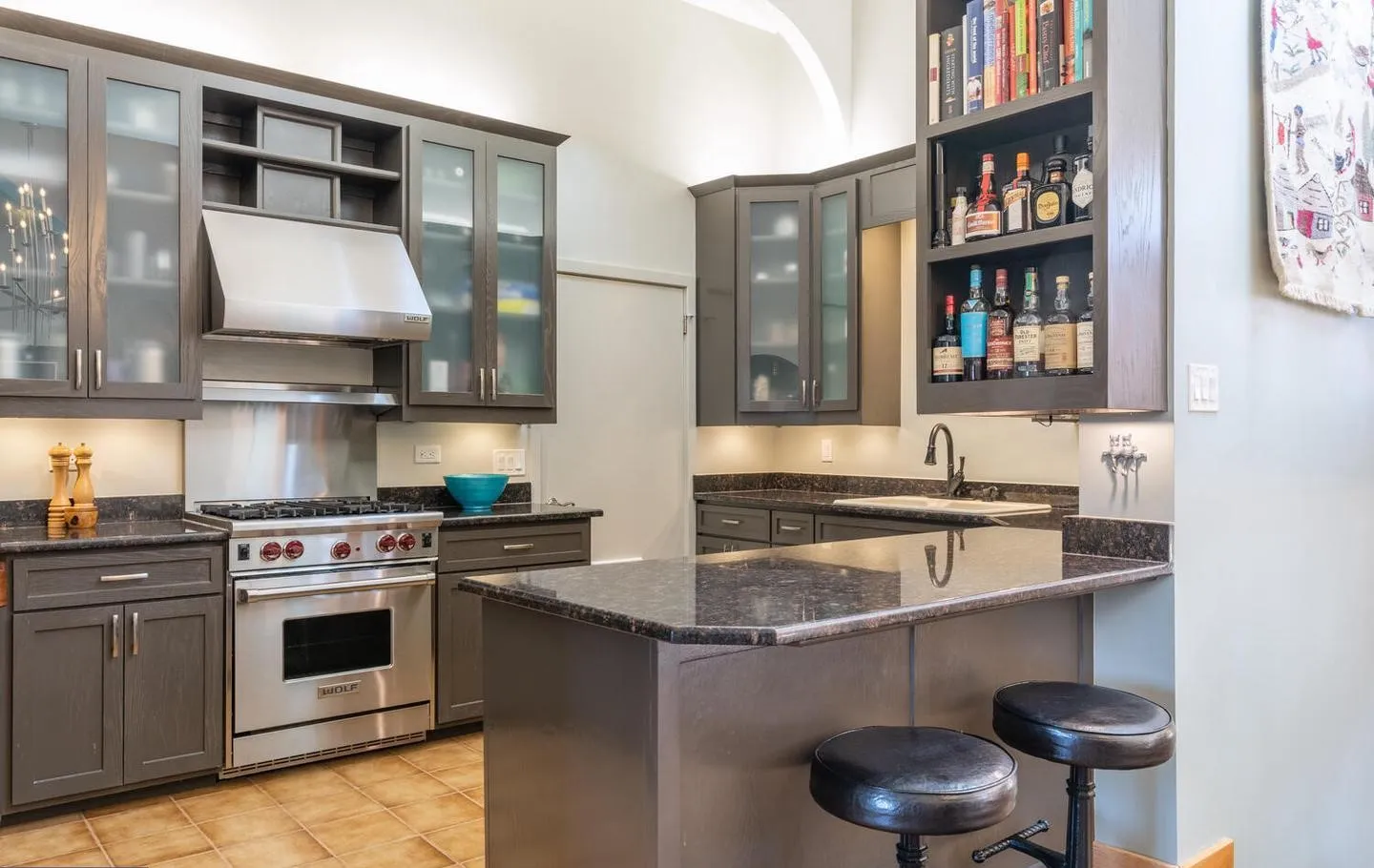 a kitchen with stainless steel appliances granite countertop a stove a sink and a refrigerator