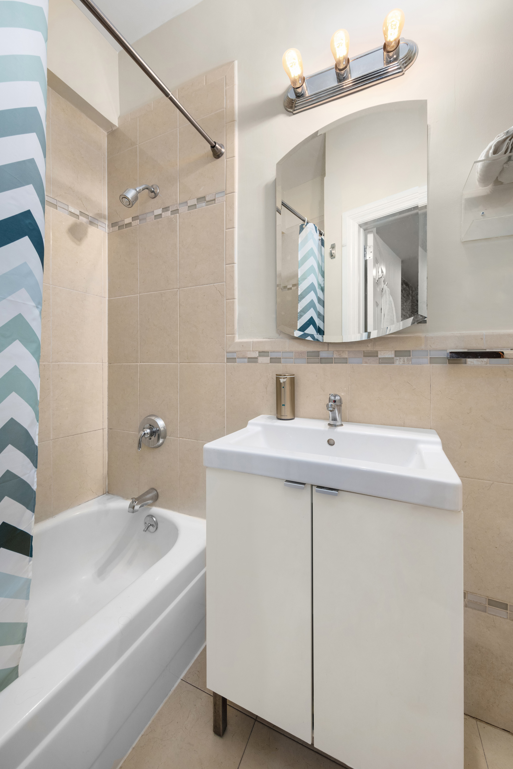143 Sullivan Street, Unit G2 Manhattan, NY 10012 - Photo 4 of 5 a bathroom with a sink and a mirror