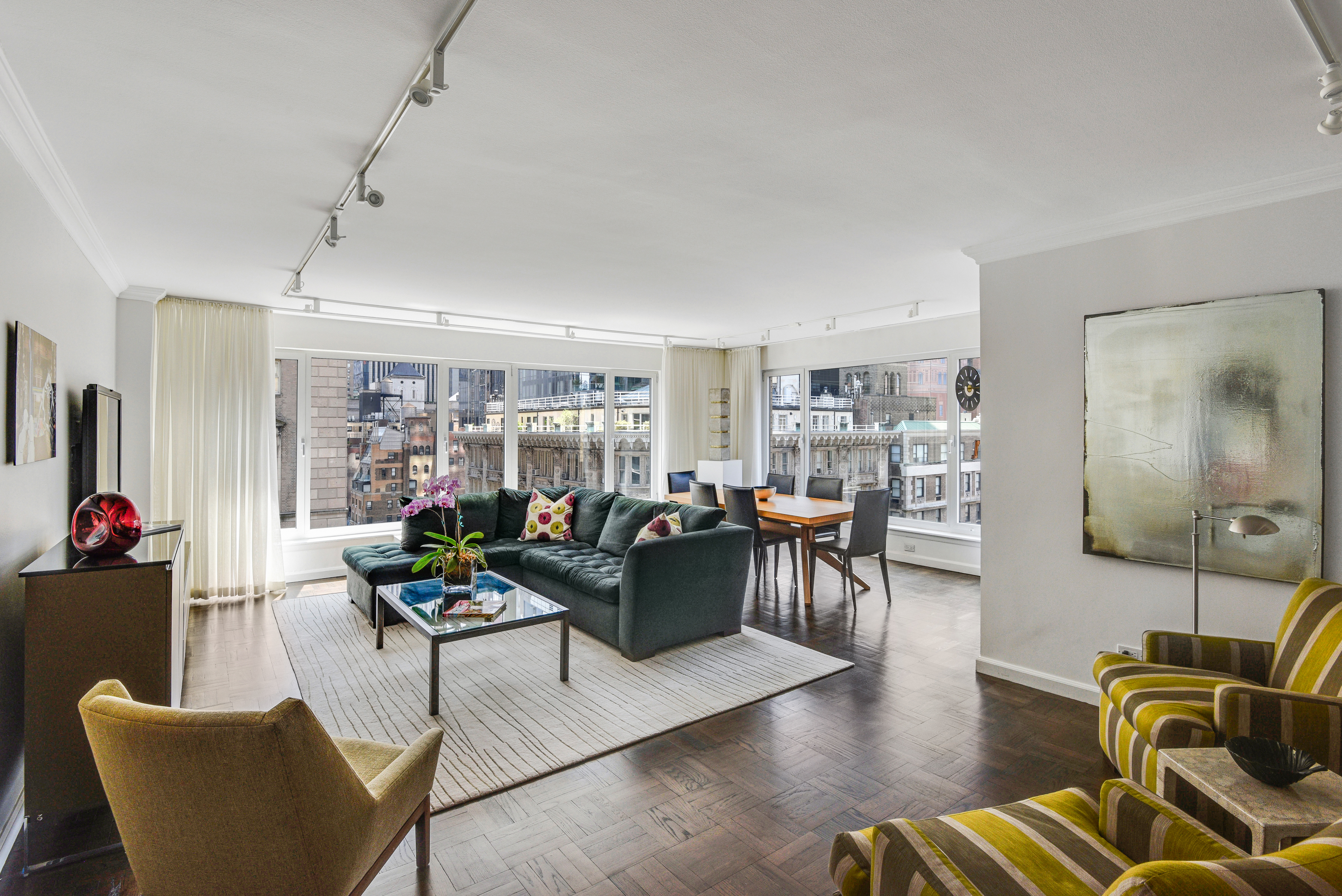 200 Central Park South, Unit 19J Manhattan, NY 10019 - Photo 2 of 12 a living room with furniture and a flat screen tv