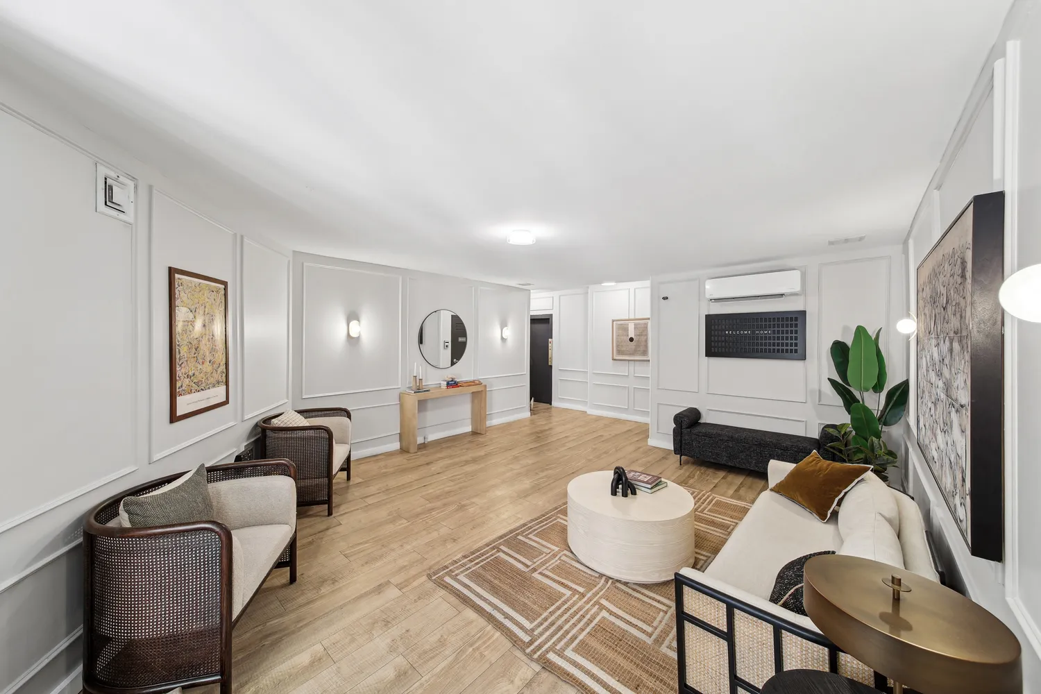 a living room with furniture and a potted plant