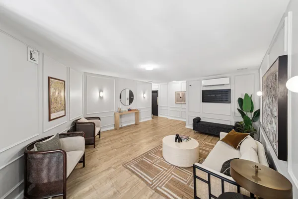 a living room with furniture and a potted plant