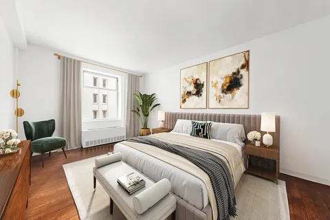 a bedroom with a bed and a couch